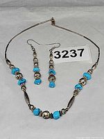 Necklace and earrings laid flat showing full set