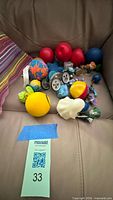 Entire group of stress balls, Thumb Chucks, figurines and wheels on leather seat