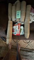 Stacks and bundles of small peat pots with seed packets placed between