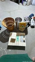 Group shot of wax blocks, metal pots, beeswax bag and wicker basket
