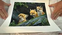 Full view of unframed print held at corners