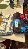 Both blankets folded side by side on table