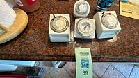 All four mechanical timers grouped on countertop