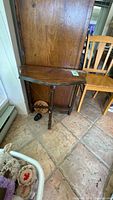 Full view of demilune table against cabinet
