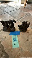 Both cast iron bookends side by side on floor
