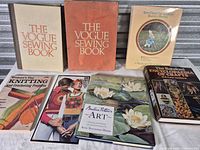 Front view of selection including two Vogue Sewing Books, Beatrix Potter’s Art, Woman’s Day knitting book and others
