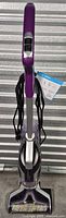 Full front view of Bissell CrossWave Pet vacuum showing overall condition and attached accessories