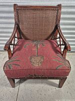 Front view of Braxton Culler rattan armchair showing woven backrest and upholstered seat