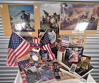 Overview of lot showing posters, flags, plush toys, CDs, playing cards, books and novelties