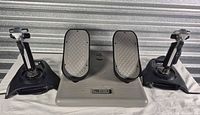 Front view showing Pro Pedals base flanked by two ST290 Pro joysticks