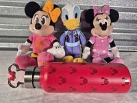 Front view of all three plush toys and bottle