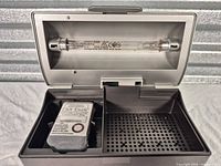 Lid open showing UV lamp, perforated platform, and Dry-Brik cartridge inside box
