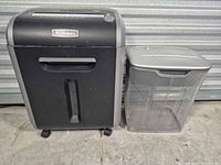 Front view of Fellowes 79Ci shredder next to mesh wastebasket