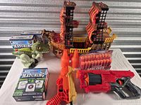 Group shot showing both Nerf blasters, darts pack, pirate ship, dinosaur, two bottle targets, two Astros games