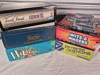 Stacked view of six game boxes showing all titles