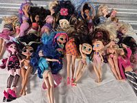 Group of mixed fashion dolls laid out