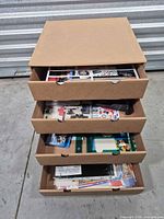 Drawer unit open showing assorted craft supplies