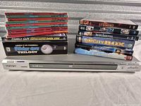 Sony DVD player with stacks of DVDs displayed on top