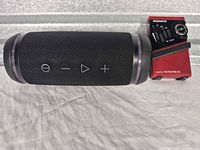 TragLab speaker next to Magnavox radio