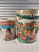 Both cylindrical containers side by side showing product graphics