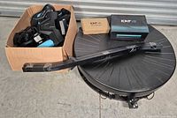 Treadmill base, frame arm, boxes visible
