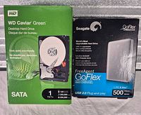 Retail boxes for WD 1TB internal SATA drive and Seagate 500GB external USB drive side-by-side