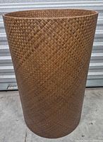 Full exterior view of tall cylindrical bamboo basket