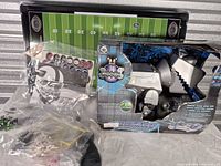 WowWee Megabyte box alongside Electric Football playfield board and bagged parts