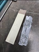 Retail box marked Mobalye beside two wrapped hangers