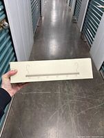sealed box showing side silhouette of hanger bar