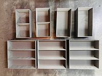 All seven grey drawer organizers showing compartment layouts