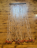 Full view of entire beaded curtain laid flat showing 52 strands and overall length