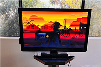 Front view of Panasonic plasma TV on stand with screen powered on
