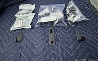 All three types of hooks displayed with sealed bags behind and sample hooks in front