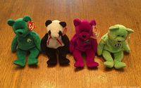 Group shot of all four Ty Beanie Babies plush toys: Erin, Fortune, Millennium, Kicks