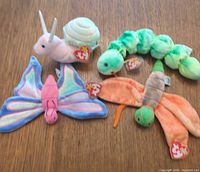 Group shot of four Ty Beanie Baby insect plush toys