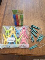 Group shot of all clothespins: sealed Trixes pack, sealed Yunlainaio pack, loose teal pegs and metal hooks