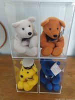 All four colored Titanic bears in individual acrylic display cases