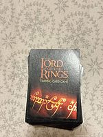 Front view of stacked cards showing standard LOTR TCG backs