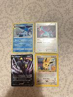 All four Pokémon cards laid out