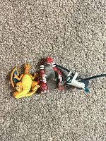 All three Pokémon figures grouped on carpet