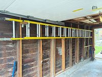 Full view of 24-ft yellow-rail extension ladder mounted on wall