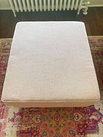 Top view of upholstered ottoman fabric texture and piping