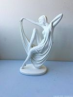 full view of white Art Deco lady figurine on base