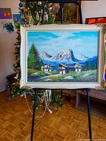 Full view of framed oil painting on easel
