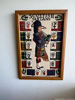 Front view of framed Scottish tartans textile art