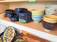 Group view of blue ribbed soup bowls, striped bowls, tulip platter