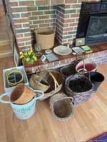 Overall view showing multiple wicker baskets, ceramic pieces, faux flowers and planter pot