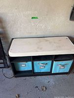 front view of bench showing cushion and three fabric bins