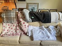 All blankets and linens arranged on couch